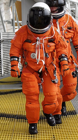 dressed in their helmets and launch-and-entry spacesuit