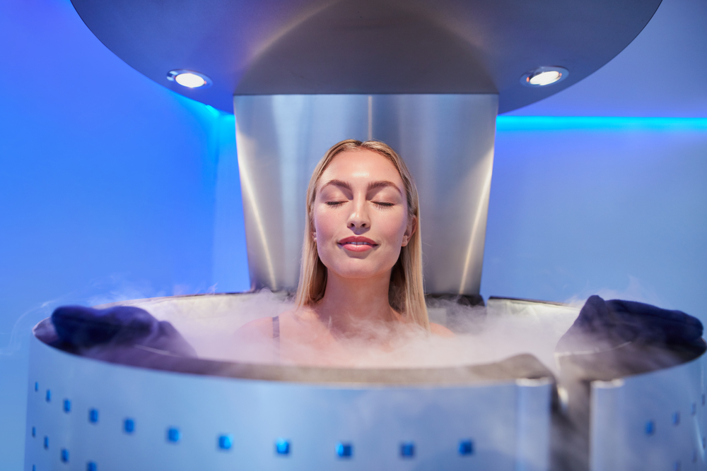 Portrait of happy young woman in a whole body cryotherapy cabin with her eyes closed(Jacob Lund)s