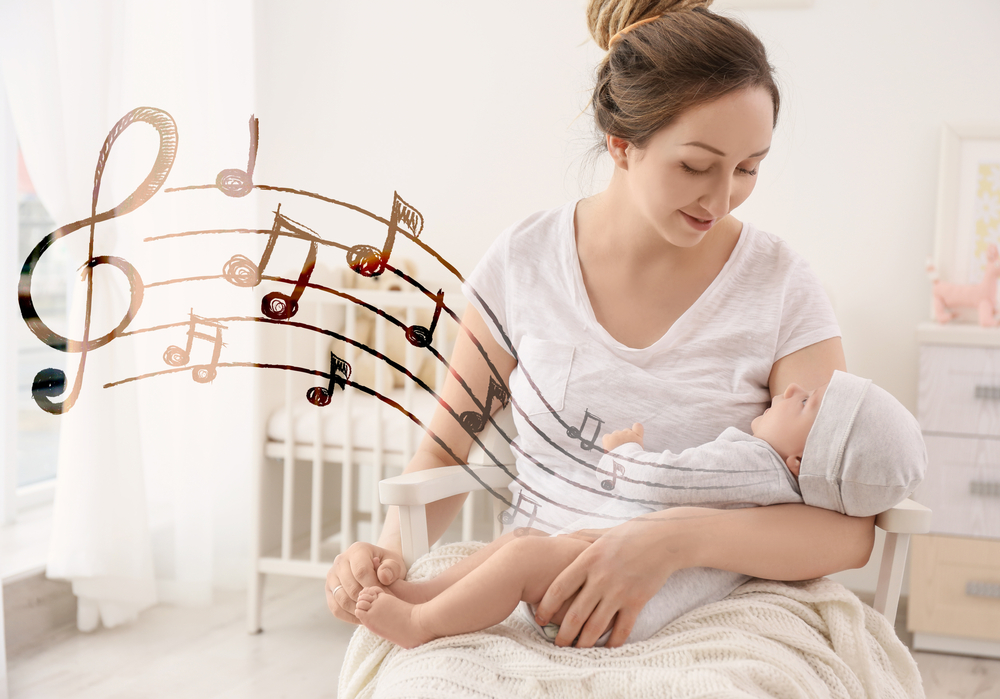 Mother with baby at home. Lullaby songs and music concept(Africa Studio)s