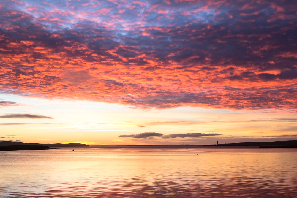 Multicolor clouds above calm North sea in Orkney town during sunrise(Maciej Orlicki)s