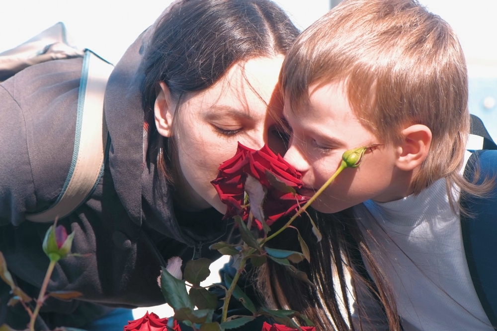 Mother and son together sniffing a rose(Vadim Zakharishchev)s
