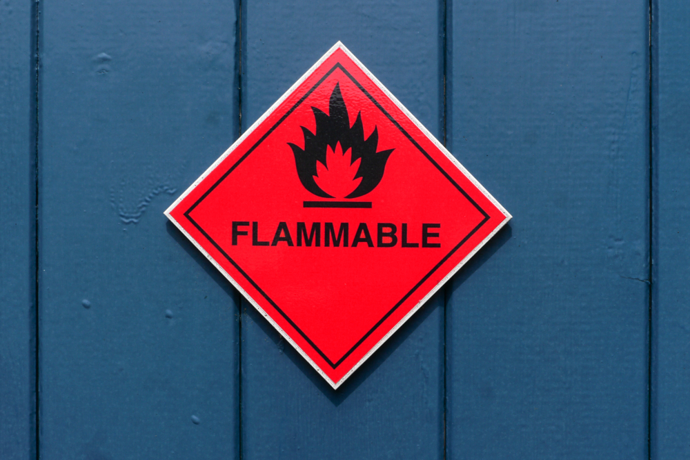 Red diamond shape flammable warning sign on red door(larry mcguirk)S