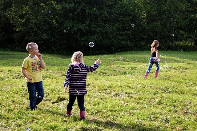 children playing with soap bubble