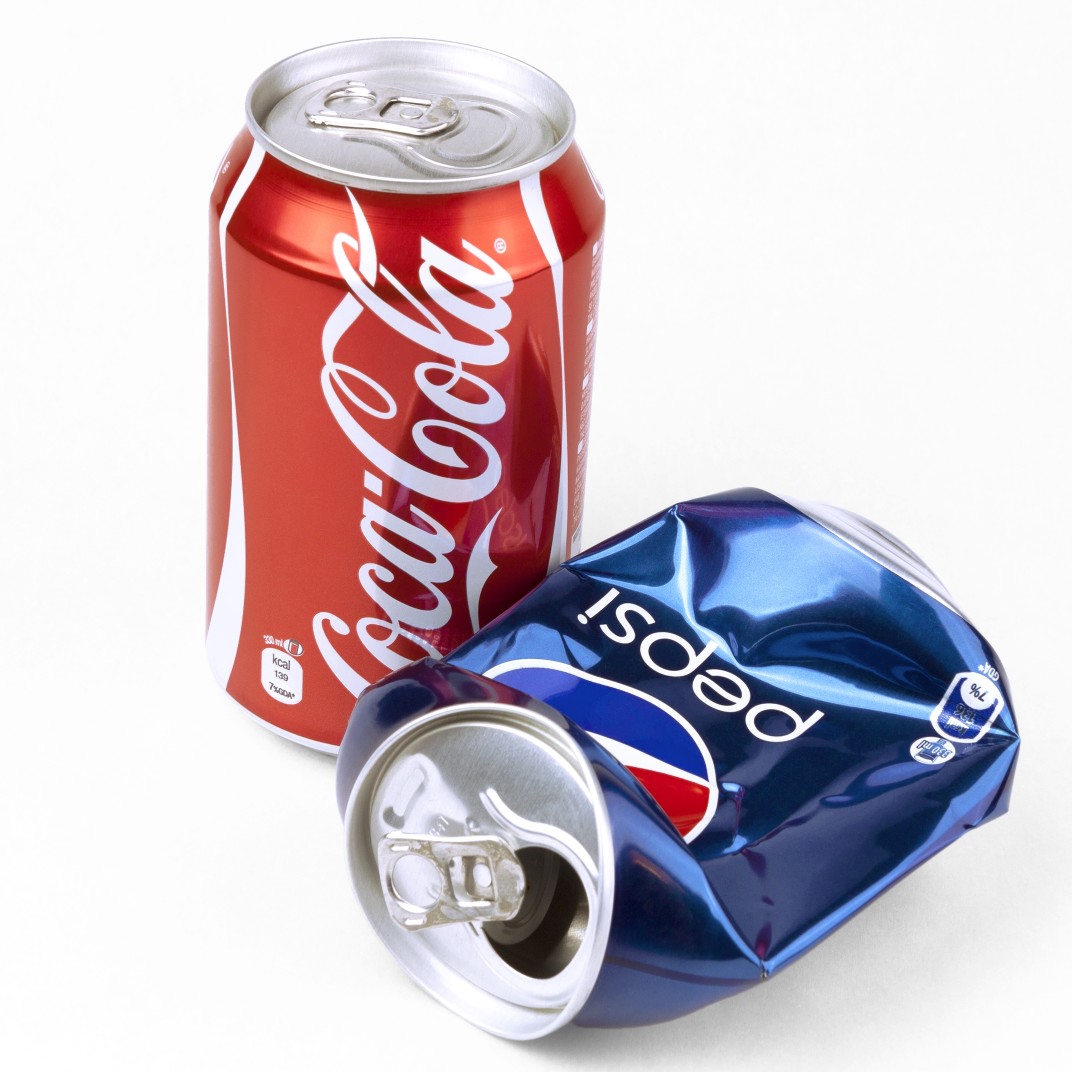 concept-of-competition-as-pepsi-can-is-lying-empty-and-crashed-while-coca-cola-is-still-full-and_t20_lRoZA8