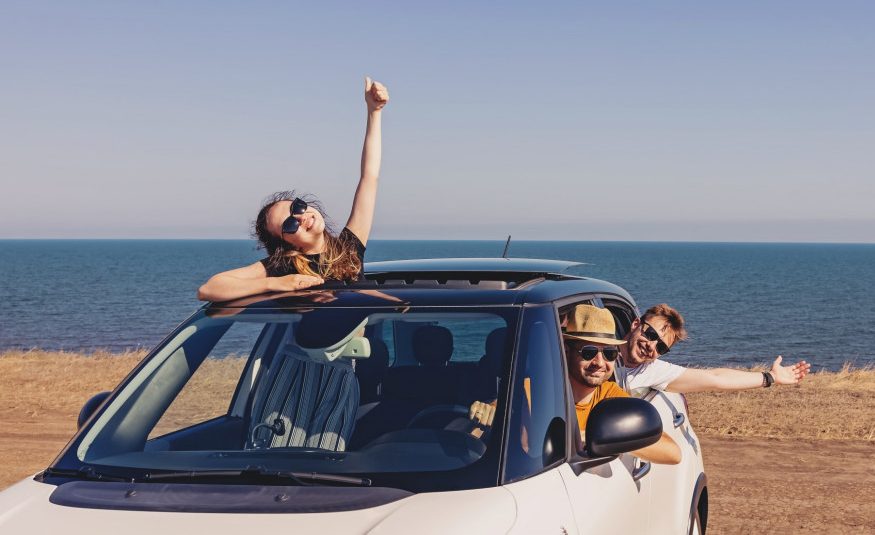 happy-smiling-fiends-in-the-car-near-the-sea-summer-road-trip_t20_gLZwN7