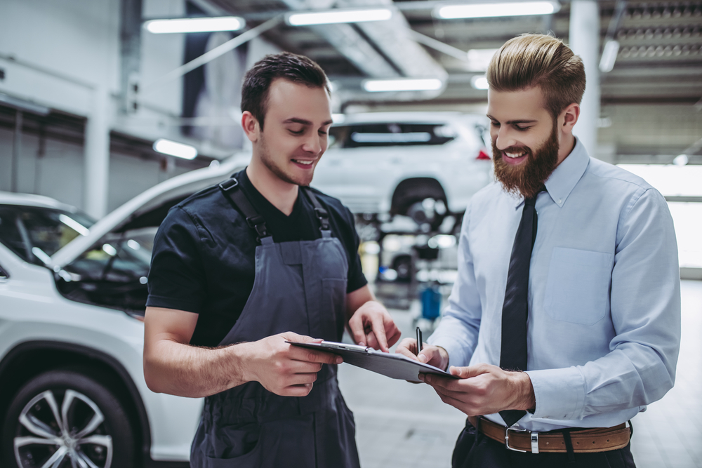 Handsome,Businessman,And,Auto,Service,Mechanic,Are,Discussing,The,Work