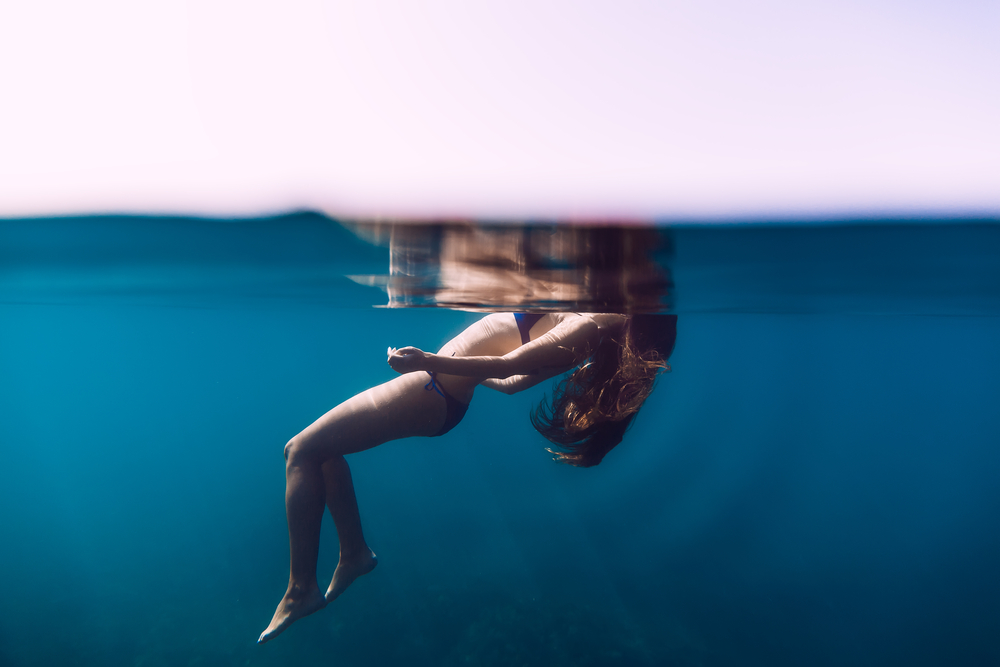 Woman,Floating,In,Ocean,,Girl,Is,Relaxing.,Underwater,Photo