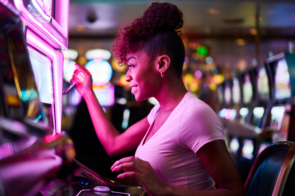 Happy,Woman,Gambling,At,Casino,Playing,Slot,Machine