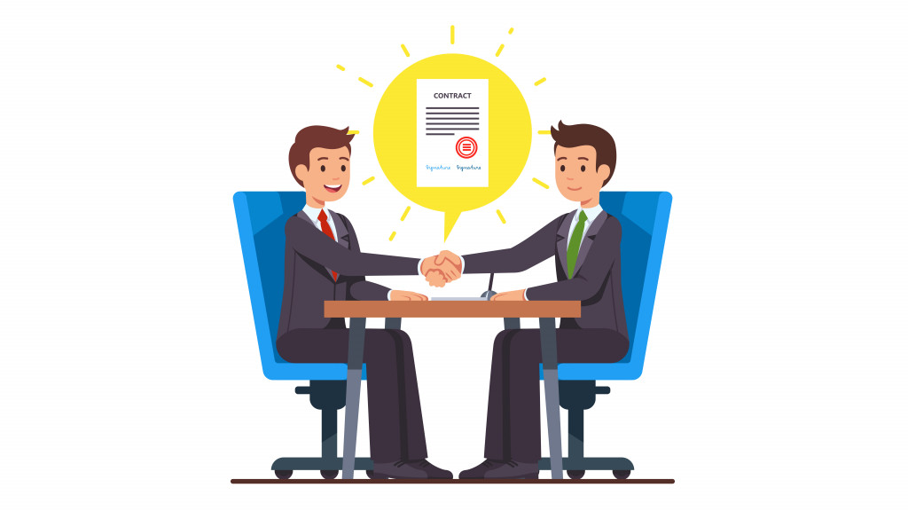 Business man partnership beginning. Businessman partners shaking hands after signing contract agreement closing deal sitting at negotiations table